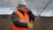 Worker with cell phone and adjustable wrench on field