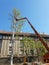 Worker with a chainsaw trimming the tree branches on the high mobile platform