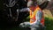 Worker check hydraulic pipes near tractor