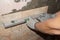 a worker checks the glued ceramic tiles with a building level