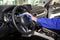 Worker cleaning automobile steering wheel with rag. Car wash service