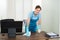 Worker Cleaning Desk With Rag