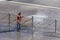 Worker cleaning driveway with gasoline high pressure washer splashing the dirt, asphalt road fence. High pressure cleaning