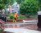 Worker cleaning driveway with high pressure washer splashing the dirt,professional cleaning services