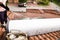 Worker cleaning solar water heater on roof during maintenance