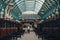 Worker cleaning up chewing gums inside empty Apple Market in Covent Garden Market, London, UK