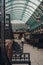 Worker cleaning up chewing gums inside empty Apple Market in Covent Garden Market, London, UK