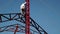 Worker climbs up steel beam in a high rise building construction