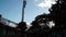 Worker climbs up a steel column in a high rise building construction