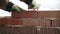 Worker in Close up of industrial bricklayer installing bricks and mortar cement brick on construction site. Worker