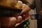 Worker coating cheese with wax in factory warehouse