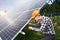 Worker connects solar panels on a green plantation. Home construction.