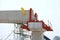 Worker constructing railways structure for electric train on blue sky as a background in the construction site