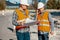 Worker and construction manager consulting on a project with eng