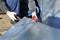 Worker on construction site cut stainless steel sheet shears of metal cutting