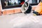 Worker on construction site pouring sealant from bucket for waterproofing cement