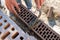 A worker at a construction site puts a brick