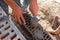 A worker at a construction site puts a brick