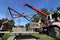 Worker controls of lifting crane for transporting concrete slabs