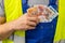 Worker counting his earnings, Colombia money, Concept of wages and labor costs in industry