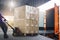 Worker Courier Unloading Package Box Out Of Cargo Container. Delivery service. Truck Loading at Dock Warehouse. Shipments.