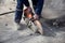 A worker cuts asphalt, saws the road surface.