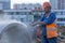 Worker cuts the concrete ring at the construction site