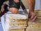 worker cuts wooden slats