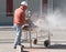 Worker Cutting Cement Block