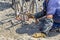 Worker cutting concrete reinforcing metal rods with torch