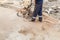 A worker cutting concrete road with diamond saw blade machine