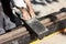 Worker cutting damping material for tram tracks