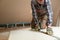 Worker cutting drywall plasterboard with construction knife. Attic renovation