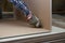 Worker cutting drywall plasterboard with construction knife. Attic renovation