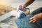 Worker cutting granite stone with an diamond electric saw blade and use water to prevent dust and heat