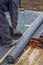 Worker cutting insulation material for basement wall 4