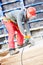 Worker cutting plywood by saw machine