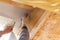 Worker cutting protective material near skylight window