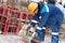 Worker cutting rebar by grinding machine