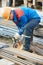 Worker cutting rebar by grinding machine