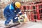 Worker cutting rebar by grinding machine