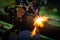 Worker cutting steel pipe with acetylene welding cutting torch a