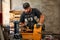 Worker cutting steel pipe with machine for threading