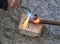 Worker cutting steel pipe using metal torch