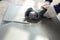 Worker cutting a tile using an angle grinder at construction sit