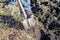 A worker digs the ground with a hand shovel in the garden, a person prepares the soil for planting crops, spring digging of the