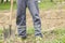 Worker digs soil with shovel in the vegetable garden