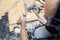 A worker dismantles the old parquet floor with a hammer and chisel. Renovation in the apartment