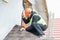 Worker dismantling roof shingles