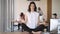 Worker do meditation sitting in lotus position on office desk